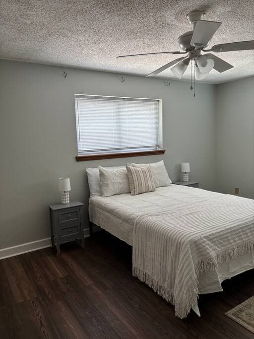 Cozy bedroom with queen bed and hardwood floors