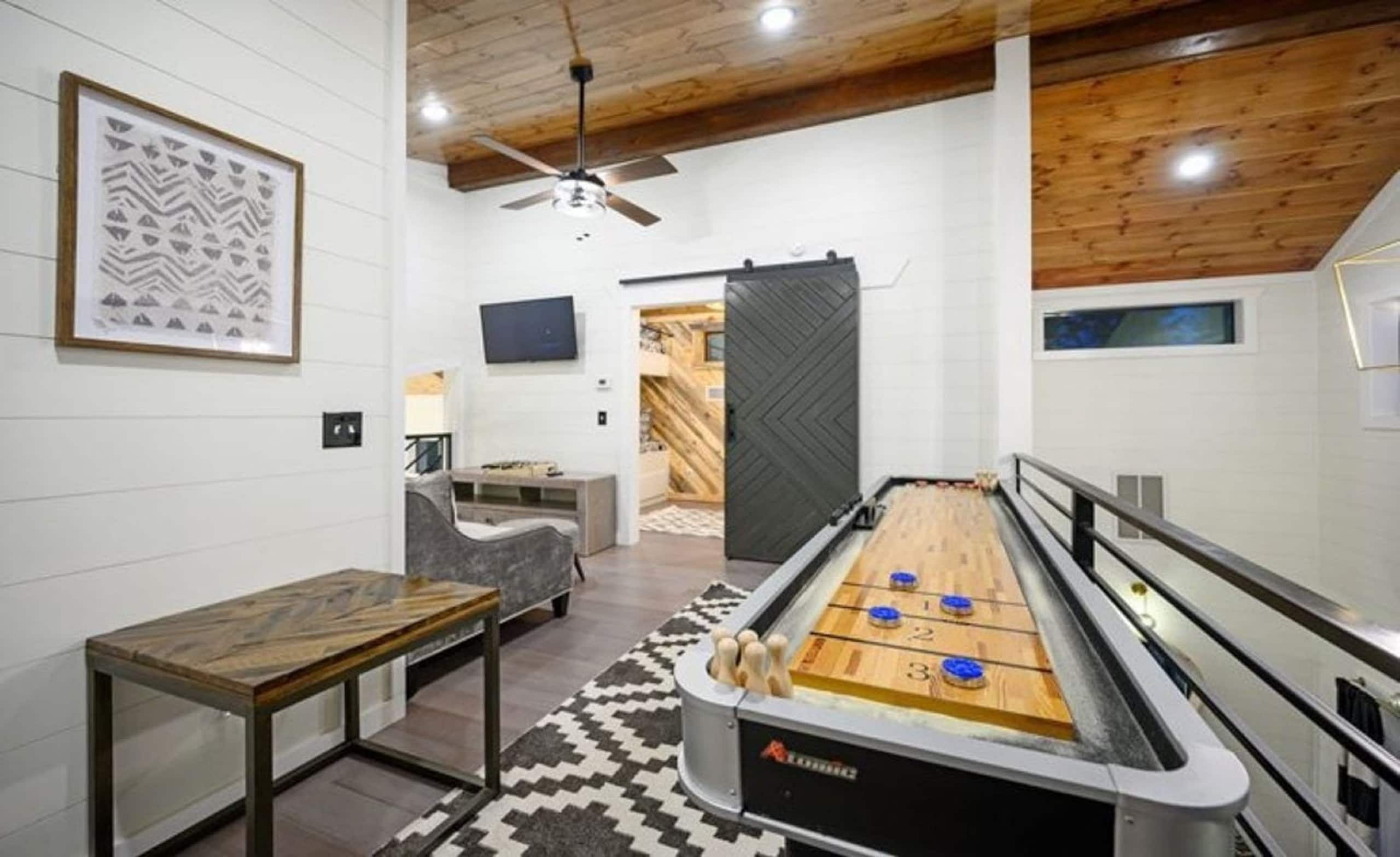 Shuffleboard table in the upstairs loft at Sublime Retreat, beside the railing over the great room